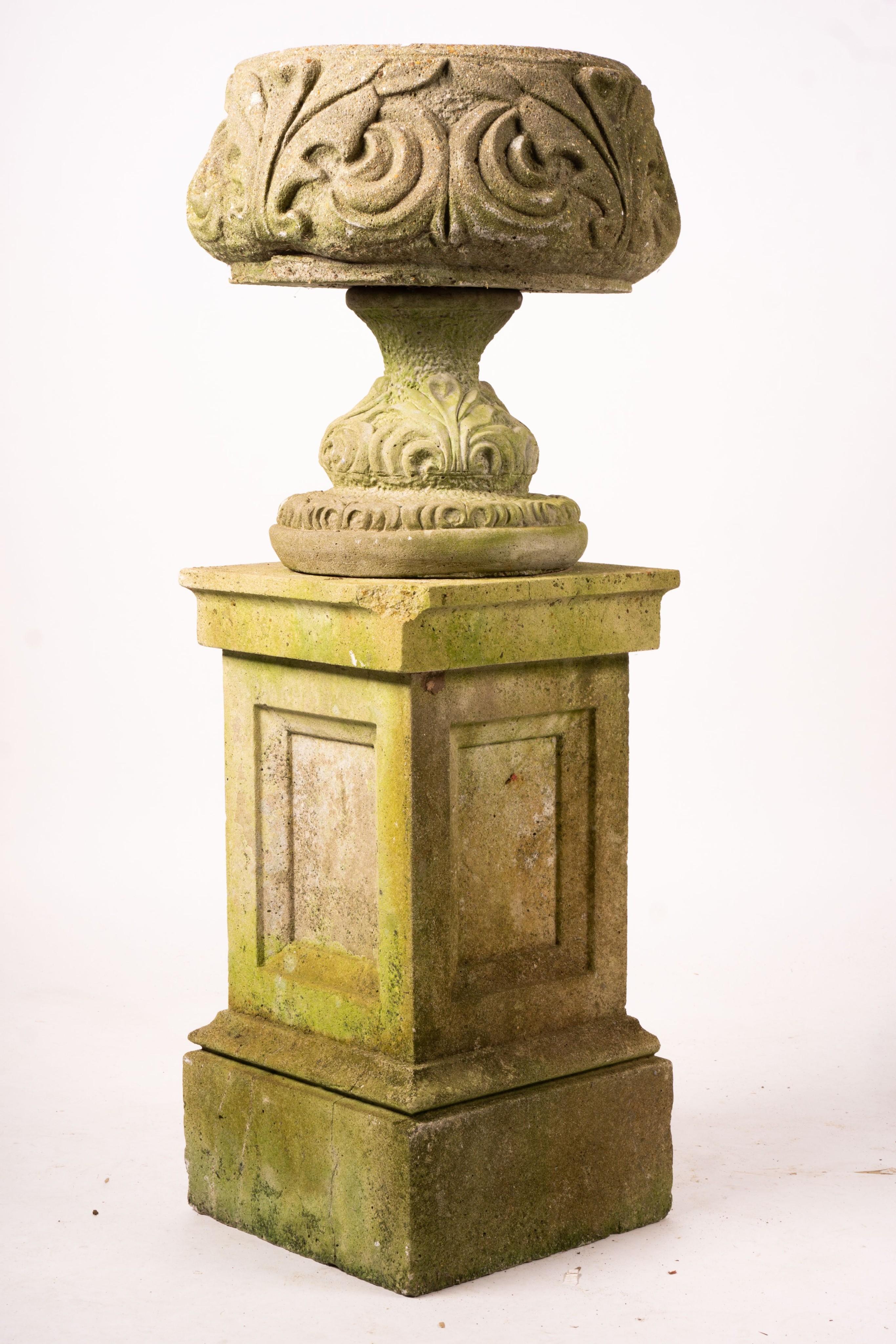 A pair of reconstituted stone circular garden planters on pedestal bases, diameter 45cm, height 110cm